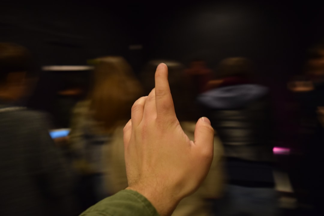 FAQ by Gamification Hub person in green long sleeve shirt showing right middle finger